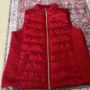 Women’s large red puffer vest with gold zipper